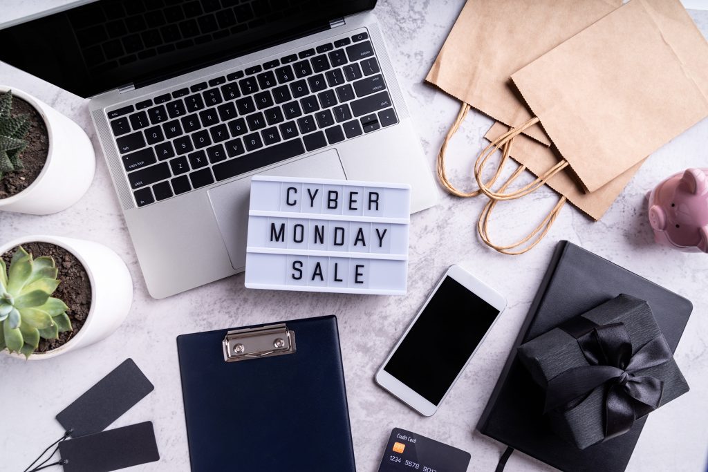 Cyber Monday shopping sale concept. Cyber monday sale text on lightbox, top view of offcice workspace ready for seasonal sales